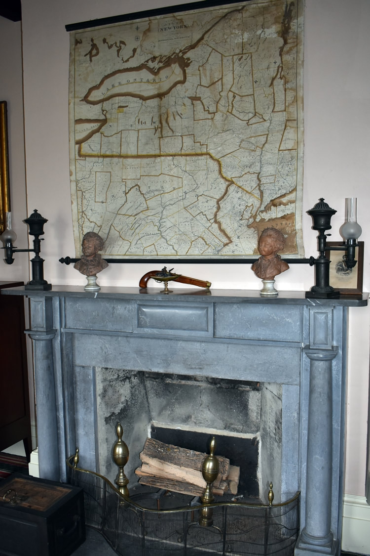 Each fireplace in the house is made of a different kind of stone.   This one is in George Clarke's office under a map of his holdings. 
